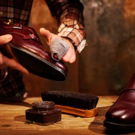 Man shining shoes with a rag.