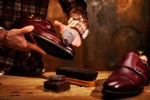 Man shining shoes with a rag.